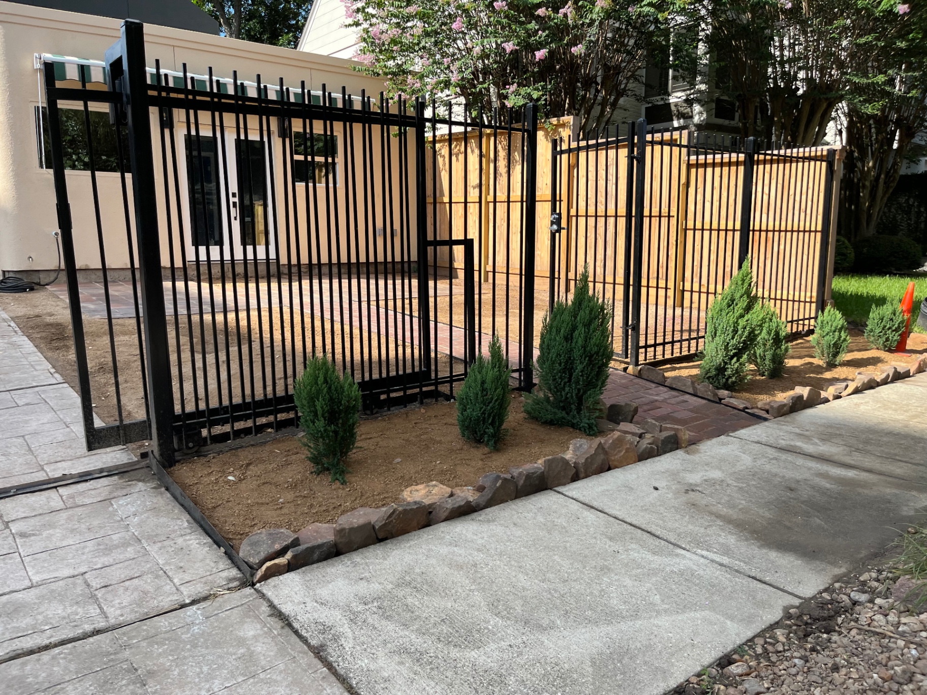 After — finished fence with landscaping